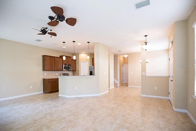 kitchen with stainless steel appliances, backsplash, visible vents, and baseboards