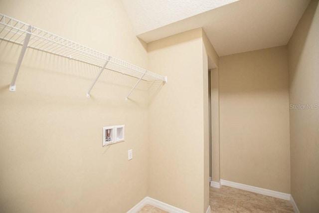 laundry room with hookup for a washing machine, baseboards, and laundry area