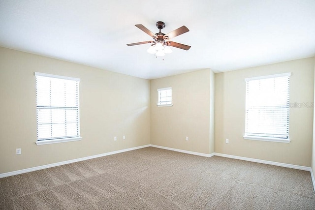 unfurnished room featuring carpet, ceiling fan, and baseboards