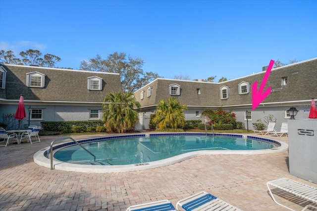 community pool featuring a patio area