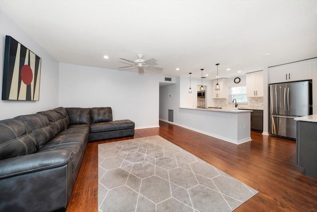 living area featuring ceiling fan, dark wood finished floors, visible vents, and recessed lighting