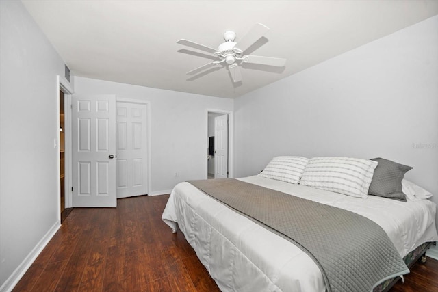 bedroom featuring a ceiling fan, visible vents, baseboards, and wood finished floors