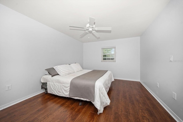 bedroom with a ceiling fan, baseboards, and wood finished floors