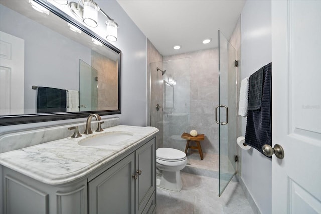 full bathroom featuring vanity, a shower stall, toilet, and recessed lighting