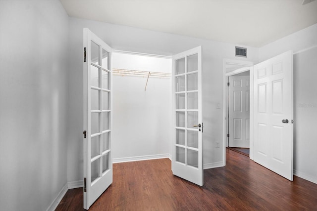 spacious closet with visible vents, wood finished floors, and french doors