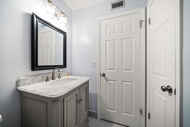 bathroom featuring vanity, visible vents, and baseboards