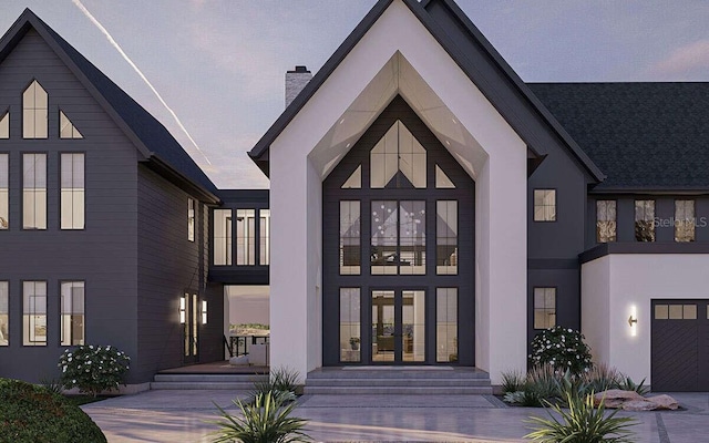 view of exterior entry with stucco siding, a chimney, and french doors