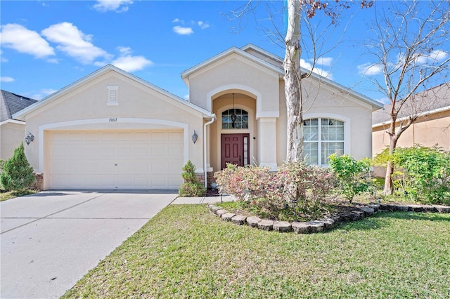 view of front of home with an attached garage, a front lawn, concrete driveway, and stucco siding