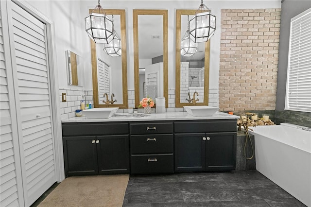 full bathroom featuring a freestanding tub, a sink, and double vanity