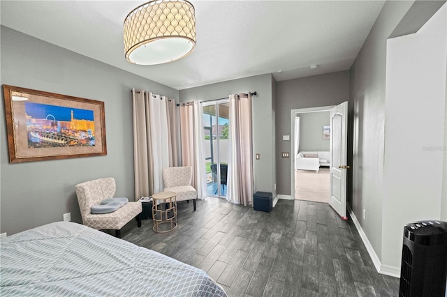 bedroom with access to exterior, baseboards, and dark wood-style floors