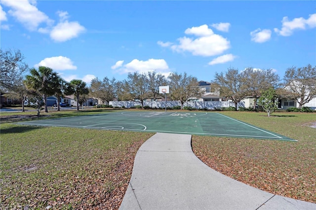 view of basketball court with community basketball court and a lawn