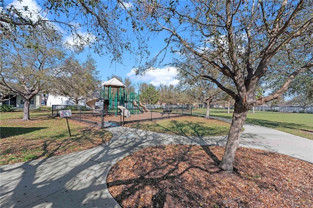 community play area with a yard and fence