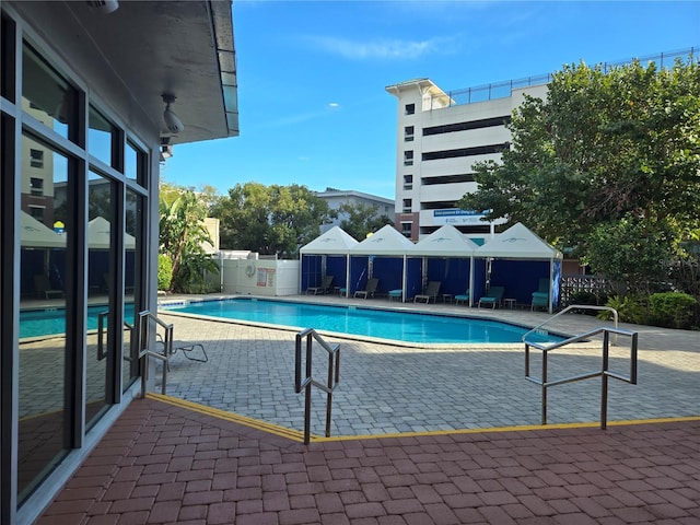 pool featuring a patio and fence