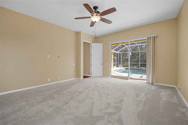 unfurnished room featuring a sunroom, carpet, baseboards, and a ceiling fan