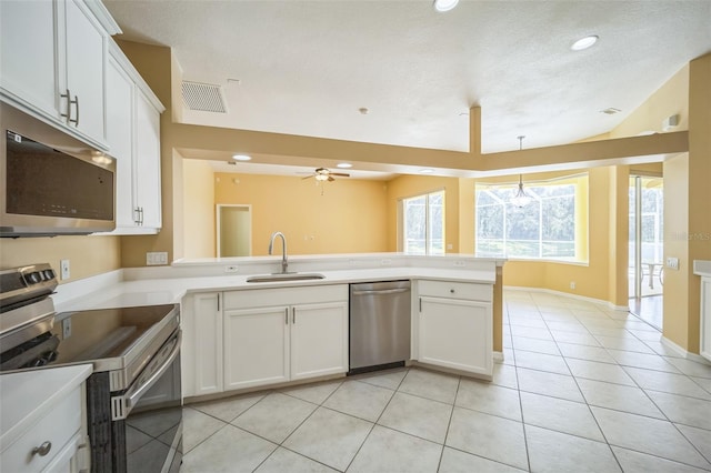 kitchen featuring light tile patterned floors, stainless steel appliances, visible vents, a sink, and a peninsula