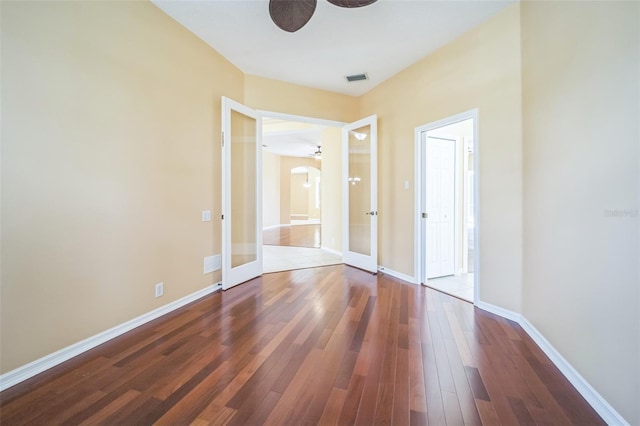 unfurnished bedroom with visible vents, french doors, hardwood / wood-style flooring, and baseboards