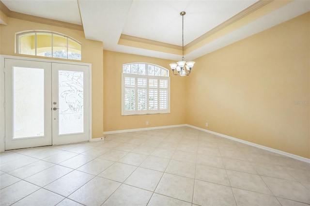 interior space with baseboards, a raised ceiling, tile patterned floors, french doors, and a chandelier