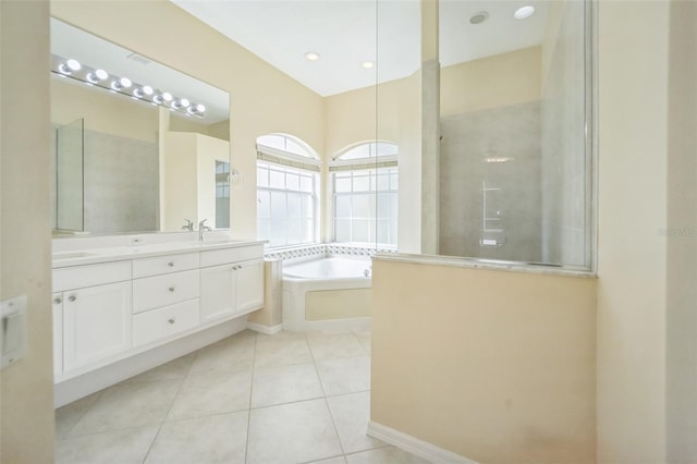 bathroom with double vanity, a sink, a bath, tile patterned flooring, and walk in shower