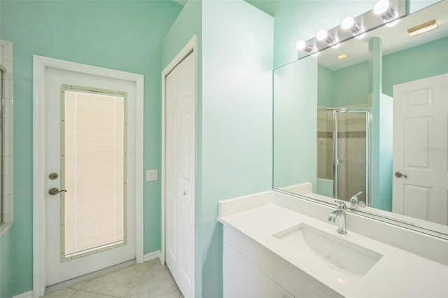 bathroom with a shower stall, vanity, and tile patterned floors