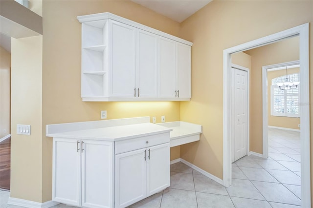 washroom with baseboards and light tile patterned floors