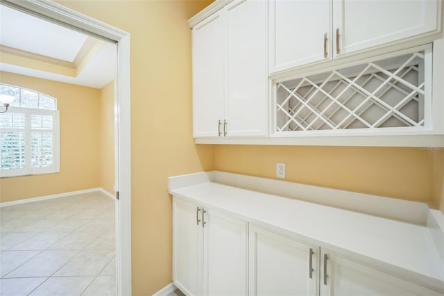 bar featuring light tile patterned floors and baseboards