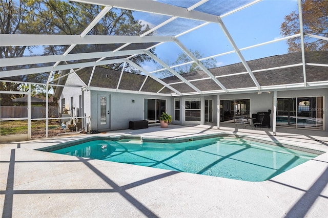 view of swimming pool with a fenced in pool, a lanai, and a patio