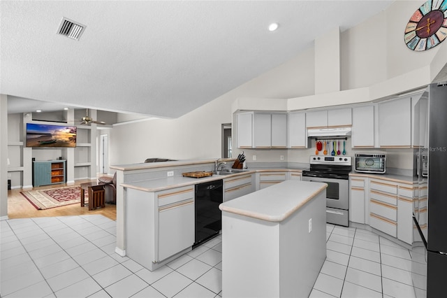 kitchen with light tile patterned floors, a peninsula, vaulted ceiling, light countertops, and black appliances