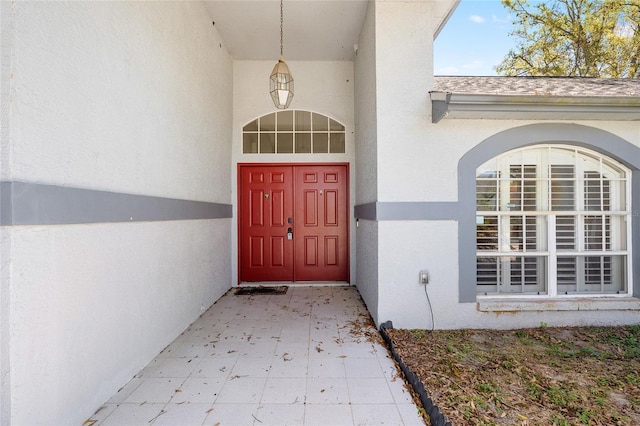 view of exterior entry featuring stucco siding