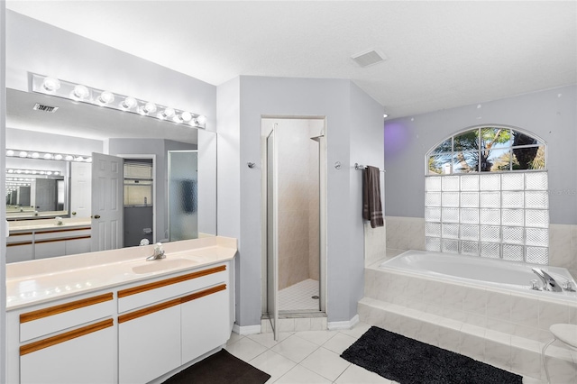 bathroom featuring a stall shower, visible vents, tile patterned floors, a garden tub, and vanity