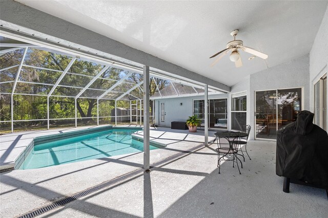 pool featuring a lanai, a patio area, ceiling fan, and area for grilling