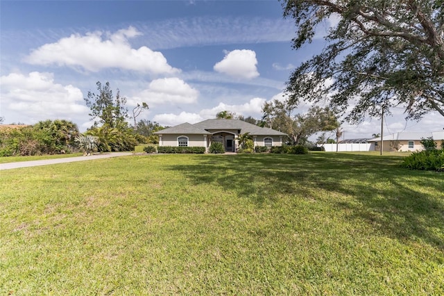 single story home with a front lawn