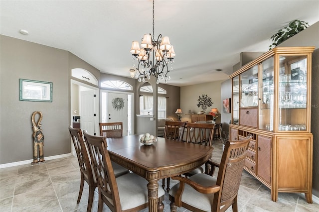 dining space with a notable chandelier and baseboards