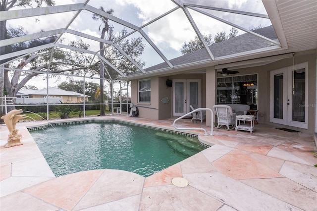 pool featuring glass enclosure, french doors, and a patio area