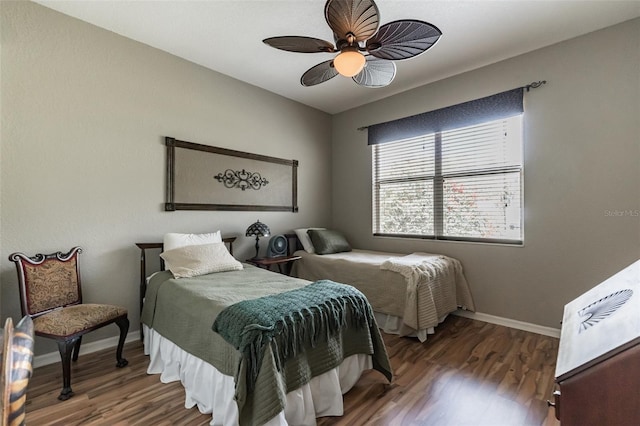 bedroom featuring ceiling fan, baseboards, and wood finished floors