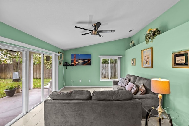 living area with lofted ceiling, ceiling fan, light tile patterned floors, and visible vents