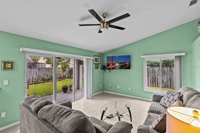 living room featuring visible vents, baseboards, lofted ceiling, ceiling fan, and tile patterned floors