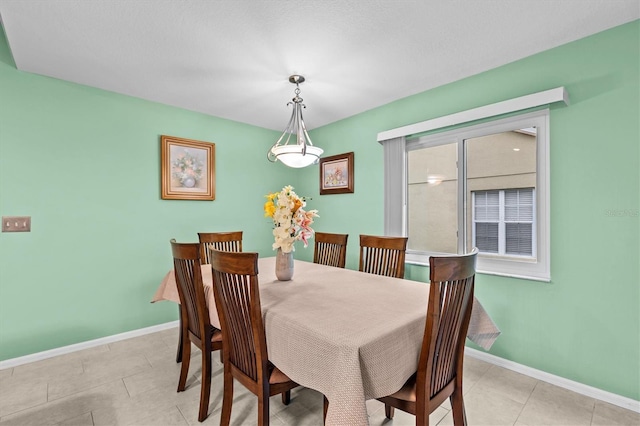 dining room featuring baseboards and light tile patterned floors