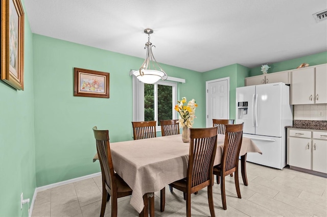 dining space with visible vents, baseboards, and light tile patterned flooring