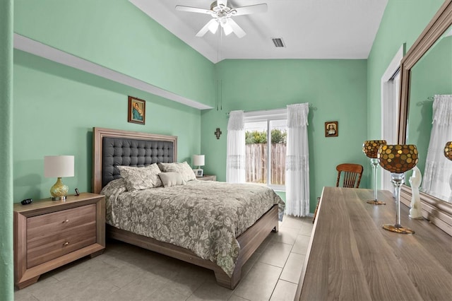 bedroom featuring a ceiling fan, lofted ceiling, visible vents, and light tile patterned flooring