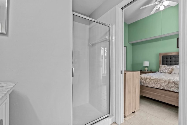 full bathroom with a stall shower, a ceiling fan, ensuite bath, tile patterned floors, and vanity