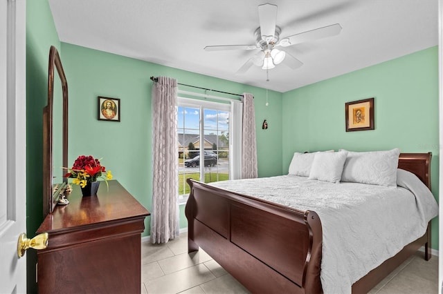 bedroom with light tile patterned floors, ceiling fan, and baseboards