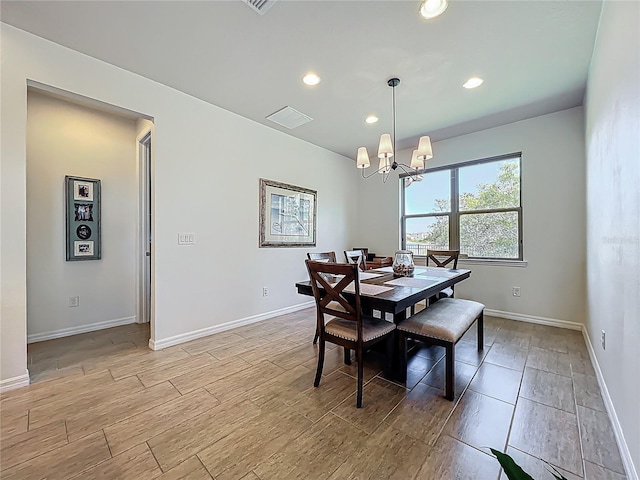 dining area featuring visible vents, light wood-style flooring, recessed lighting, an inviting chandelier, and baseboards