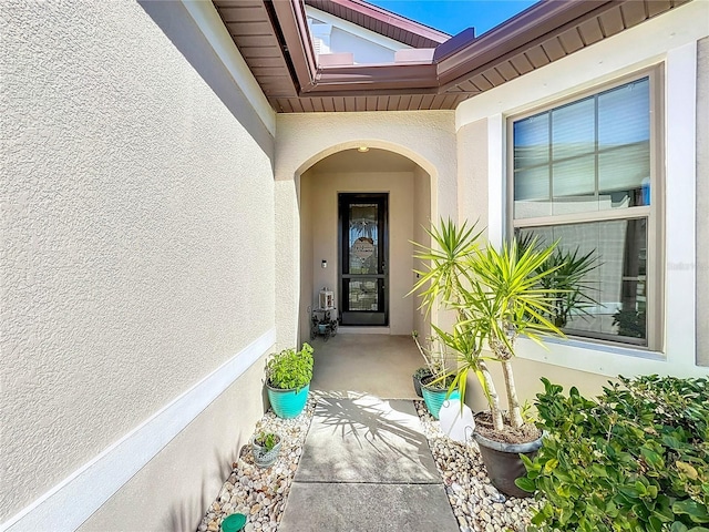 entrance to property with stucco siding