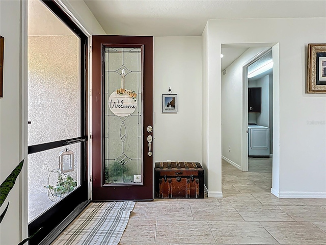 entrance foyer with washer / clothes dryer and baseboards