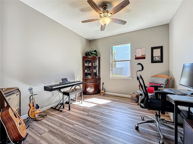 office area with ceiling fan, baseboards, and wood finished floors