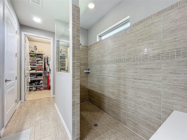 full bath featuring visible vents, a walk in closet, and a walk in shower