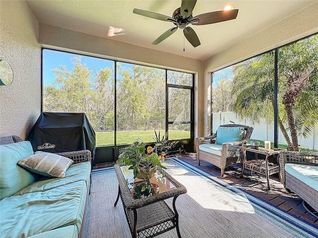 sunroom with a ceiling fan