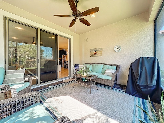 sunroom / solarium featuring a ceiling fan and a wealth of natural light