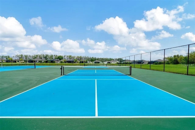 view of sport court with fence