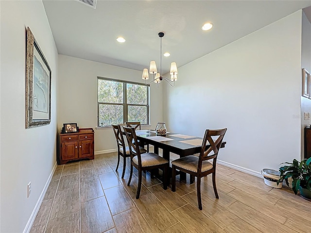 dining room featuring recessed lighting, baseboards, a notable chandelier, and light wood-style flooring